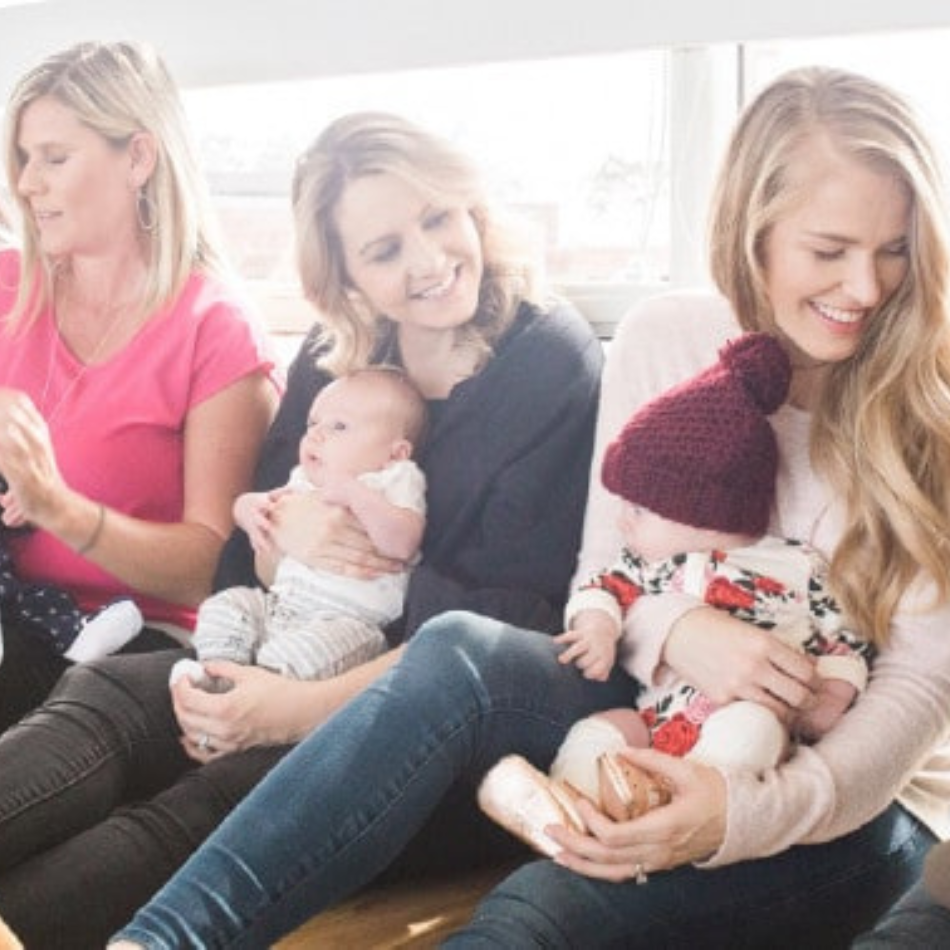 Smiling Group of Moms holding their babies