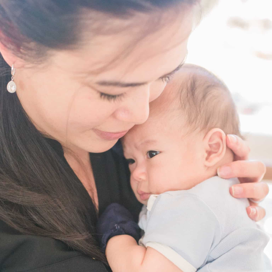 Mother comforting and holding her baby closely