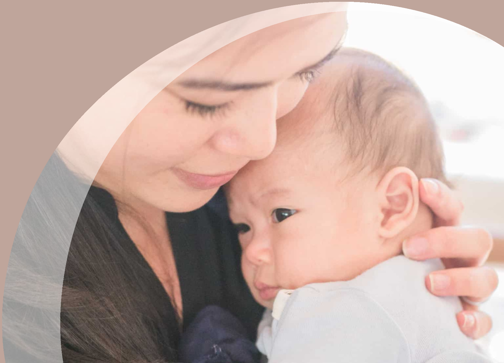 Mother comforting and holding her baby closely