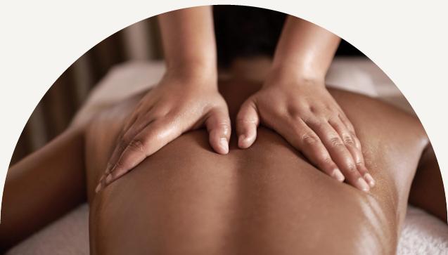 Woman face down on a massage table receiving a massage