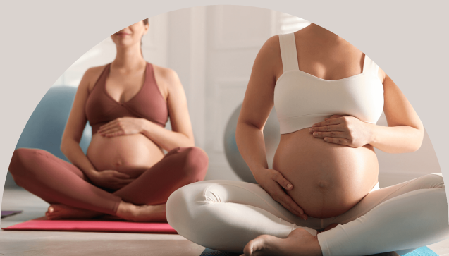 Group of women sitting cross-legged on mats caressing baby belly and practicing breaths