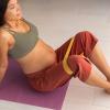 Pregnant woman on yoga mat doing stretches